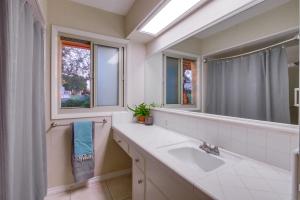 a bathroom with a sink and a mirror at Red Hawk Coastal Estate in San Diego +102 photos