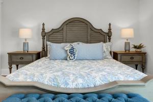 a bedroom with a bed with two night stands and two lamps at Sea Haven by Sea Scape Properties in North Topsail Beach