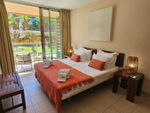 a bedroom with a bed and a large window at Charming apartment Herdade dos Salgados - Vila das Lagoas T2 in Guia +49 photos