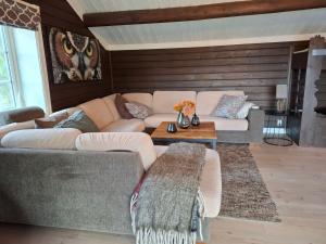 a living room with a couch and a table at Libeli Panorama in Lona