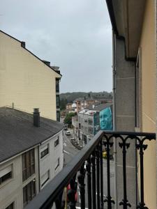 a view of a city from a balcony of a building at Avanza 4 Plaza Galicia in Sarria +18 photos