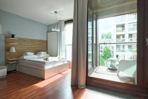 Postel nebo postele na pokoji v ubytování GO Apartments - ApartHotel