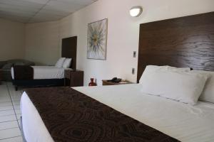 Postel nebo postele na pokoji v ubytování Hotel Sntenario