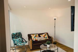 a living room with a couch and a chair at Casa da Vira - Alojamento Local in Arcos de Valdevez