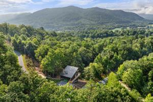 an aerial view of a house in the middle of a forest at Little Bear Lodge, 3BR2BA private cabin in Cosby, TN Gorgeous outdoor space, fire pit, hot tub in Cosby