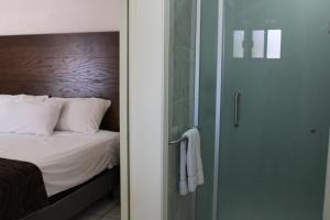 Postel nebo postele na pokoji v ubytování Hotel Sntenario