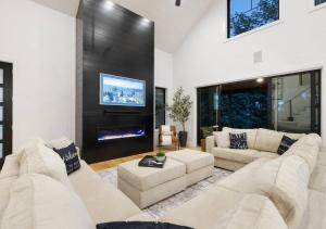 a living room with two white couches and a fireplace at Whispering Waters in Winchester