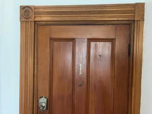 Una puerta de madera con un marco de madera en una pared. en Falls Farmstead 1865 Ellis House Cozy and Comfy Apt #1, en Ellsworth