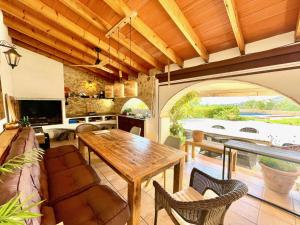 a living room with a wooden table and a kitchen at Casa rural exclusiva con vista al mar en Calpe in Empedrola