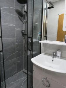 a bathroom with a shower and a sink at Apartman City in Jajce +32 photos