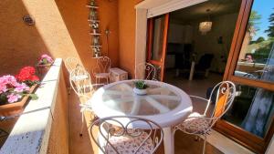 a white table and chairs on a balcony at Casa Carla in Peschiera del Garda +65 photos