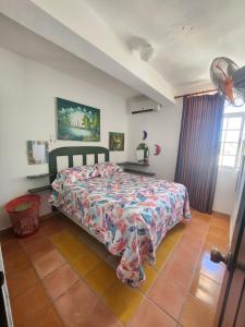 a bedroom with a bed with a comforter on it at El Castillo Dominicus in La Laguna
