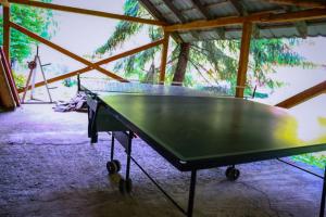 a ping pong table sitting inside of a building at Cabană în inima munților 2 - Gálkuti Kulcsosház in Bălan