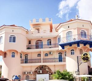a large white building with balconies on it at El Castillo Dominicus in La Laguna
