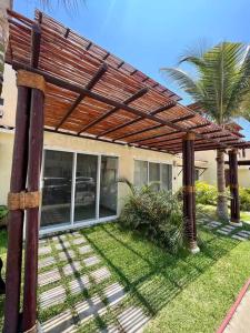 a wooden pergola in front of a house at Villa Sol Terrasol Acapulco Diamante in Acapulco