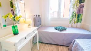 a bedroom with a bed and a table with flowers on it at Casa Carla in Peschiera del Garda +68 photos