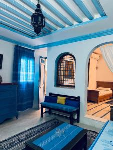 a living room with a blue couch and a bed at Dar kenza Tunis in Tunis +33 photos