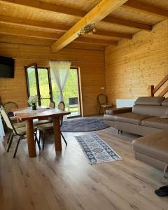 a living room with a couch and a table at Cabana Izvorul Rece Maramureş in Baia-Sprie