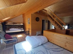 a bedroom with a bed and a staircase in a cabin at Trein d'Ustou in Ustou