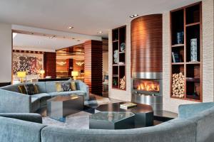 a living room with couches and a fireplace at Sheraton Sopot Hotel in Sopot