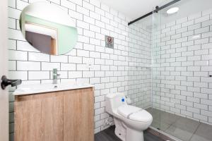 a bathroom with a toilet and a sink and a mirror at Terrazas in Bogotá