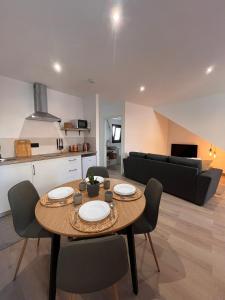 a living room with a table and chairs and a couch at Apartamento Peña in Sardina