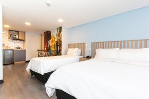 a hotel room with two beds and a kitchen at Terrazas in Bogotá +157 photos