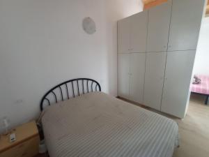 a bedroom with a bed and white cabinets at Da Zia Vecchia in Cervia