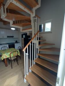 a staircase in a house with a kitchen and a table at Da Zia Vecchia in Cervia +1 photo