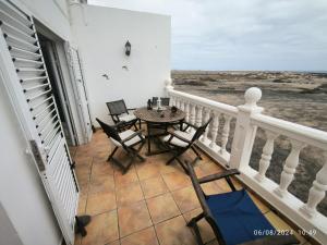 a patio with a table and chairs on a balcony at Casa Frasca in Teguise