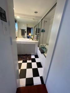 a bathroom with a black and white checkered floor at Seaside Getaway @ Swallow House Suite #2 in Cape Town