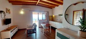 a kitchen with a desk and a table with a mirror at The Black Horse Canarias - Adults Only in Maspalomas