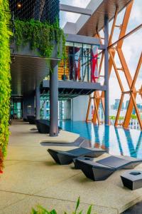 a building with a pool in the middle of it at Scarletz Suites KLCC by M Suites in Kuala Lumpur