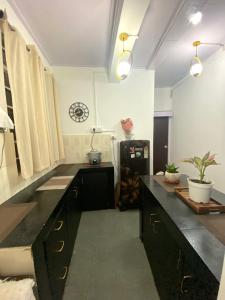a kitchen with a black counter top in a room at Noor Lyang in Gangtok