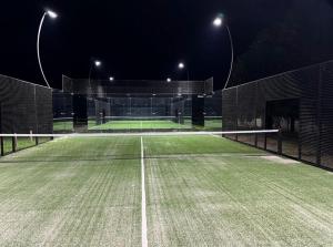 an empty tennis court at night with lights at Cabañas Avandaro Santo Boutique in Valle de Bravo