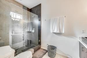a white bathroom with a shower and a toilet at Covered Patio and Grill Colorful McAllen Home in McAllen +18 photos