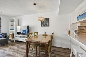 a dining room and kitchen with a table and chairs at Spanish Trace 243 in St. Augustine