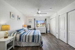 a bedroom with a bed and a ceiling fan at Spanish Trace 243 in St. Augustine