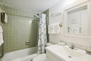 a bathroom with a sink and a toilet and a tub at Spanish Trace 243 in St. Augustine