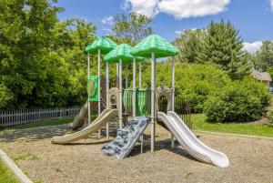 a playground with slides and umbrellas in a park at Pine Brook 416 I Corporate 15Br Apartment ! Pool in Newark
