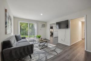 a living room with a couch and a table at Pine Brook 816 I Corporate 2Br Apartment ! in Newark