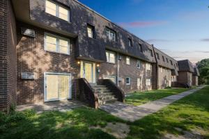 a large brick building with stairs in front of it at Pine Brook 816 I Corporate 2Br Apartment ! in Newark