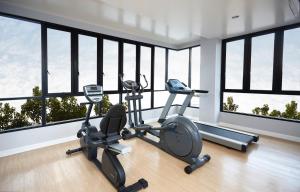 a gym with two exercise bikes in a room with windows at Praso@Ratchada12 in Bangkok