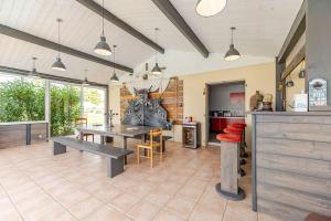 a kitchen with a table and a dining room at Maison de vacances 3 chambres avec piscine in Mourens