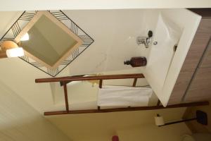a bathroom with a mirror and a sink at Sonho Paixão in São Vicente