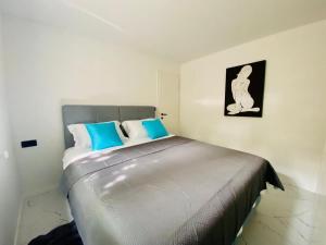 a bedroom with a bed with blue and white pillows at Apartment Daria in Postira