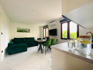 a living room with a green couch and a table at Apartment Daria in Postira