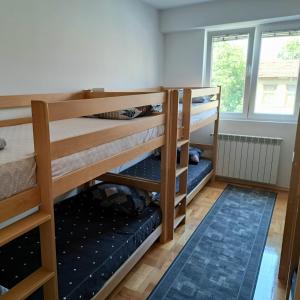 a room with two bunk beds and a window at Spacious Hostel Rooms in Skopje +9 photos