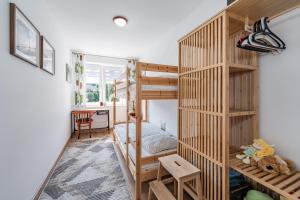 a room with a bunk bed and a desk at Leśna Enklawa in Zagórze