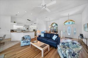 a living room with a blue couch and a table at Southern Breeze in Rotunda-West